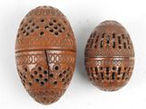 pair of carved wooden eggs with holes and holes in them