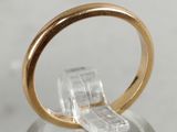 a close up of a gold ring on a clear surface