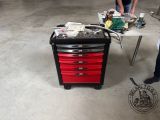 a man standing next to a table with a tool box on it