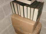 many books stacked on top of each other in a room