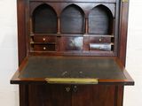 an old wooden desk with a black top and a metal drawer