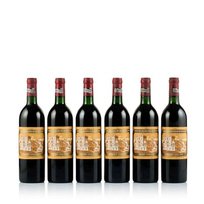 four bottles of wine are lined up in a row