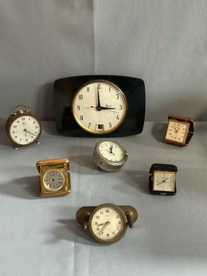 de nombreux types d'horloges exposés sur une table