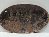 a metal plate that has a rusted surface on it