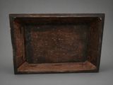 an old wooden box with a handle on a gray background