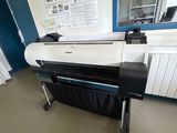 a large printer sitting on a stand in a room