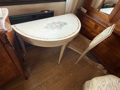 a small table and two chairs in the corner of a room