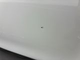 a close up of a white car with a bird on it ' s hood