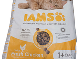 a cat laying on top of a bag of food