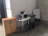 a small table with a microwave and a refrigerator in a room