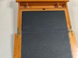 a black slate in a wooden box on a table