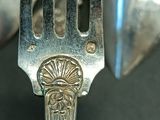 a person holding a silver fork in their hand