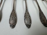 five spoons that are sitting next to each other