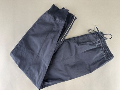a pair of blue pants laying on top of a white surface