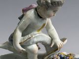 a figurine of a boy sitting on top of a plate