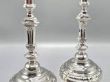 pair of silver plated candlesticks on a white background