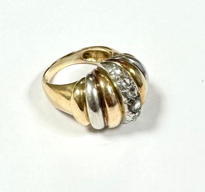 an image of a gold and diamond ring on a white surface