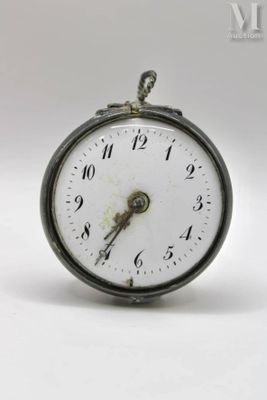 a small clock that is sitting on a white surface