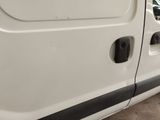 a white van with black trims parked in a parking lot