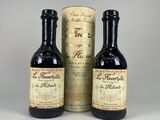 trois bouteilles de vin posées l'une à côté de l'autre sur une table