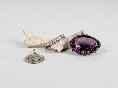 a close up of a small piece of jewelry on a white surface