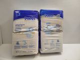 two packs of disposable baby diapers sitting on top of a counter