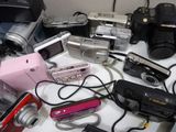 many different types of digital cameras on a table