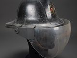 an old fireman ' s helmet with a visor on top of it