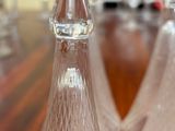 three glass vases sitting on a wooden table