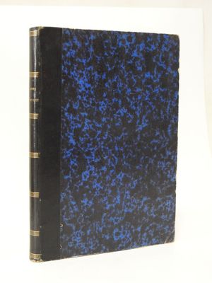 an old book with a blue cover sitting on top of a white table