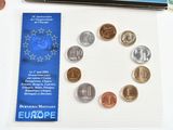 a lot of coins on the table next to a book