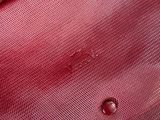 a close up of a red purse on a table