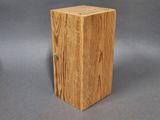 two wooden boxes are stacked on top of each other on a gray surface