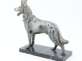 statue of a dog on a marble base on a white background