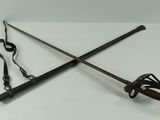two swords on a white table with a lanyard