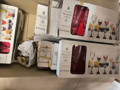 Plusieurs cartons de verres à vin sont empilés les uns sur les autres