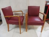 two red chairs sitting next to each other on the floor