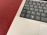 a close up of a laptop computer on a red table