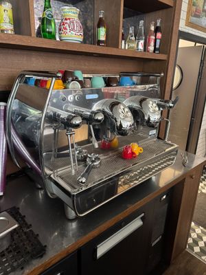 une photo d'une machine à café posée sur un plan de travail dans une cuisine
