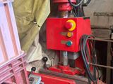 a red machine that is sitting in a garage