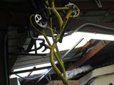 a bicycle hanging from the ceiling of a garage
