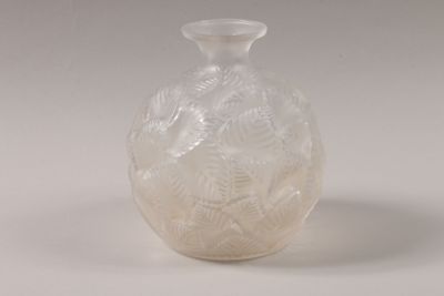 a white glass vase with a design on it