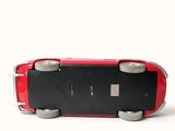 a small red skateboard sitting on top of a white surface