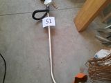 a pair of scissors sitting on the floor next to a wire
