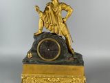 an image of a gold clock with a statue on top of it