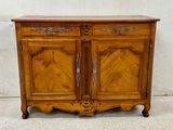 a wooden cabinet with two doors on top of it