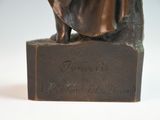 bronze statue of a woman sitting on a bench with a dog