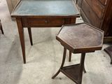 a small table with a glass top and a small table with a drawer underneath it