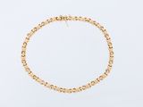 a gold bracelet with a circular design on a white background