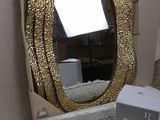 a bathroom sink with a gold mirror above it